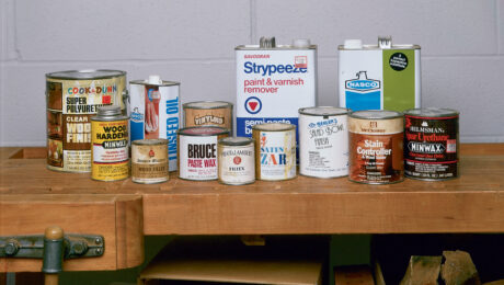 Cans of chemical solvents on a wooden workbench